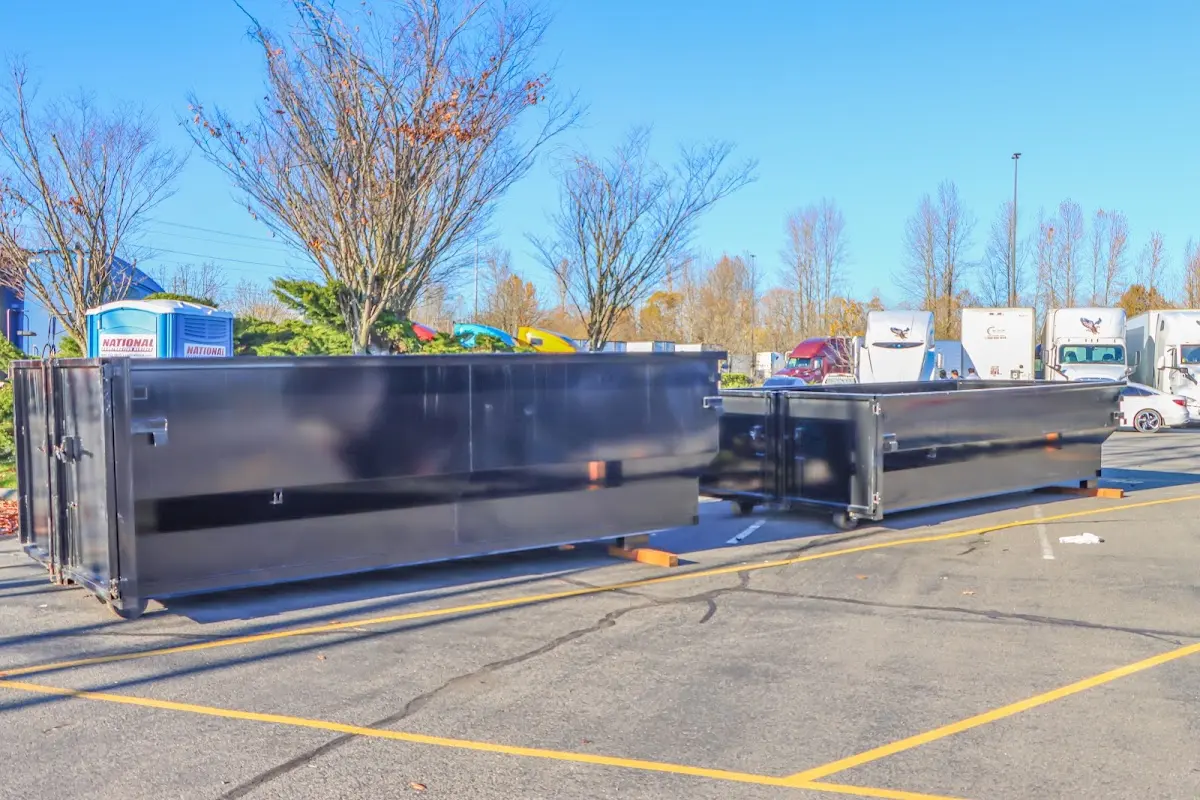 Professional dumpster rental service with roll-off container on residential driveway in Peculiar